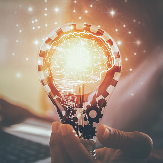 Hand holding lightbulb with innovative graphic overlays