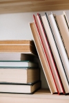 books laying down on a shelf