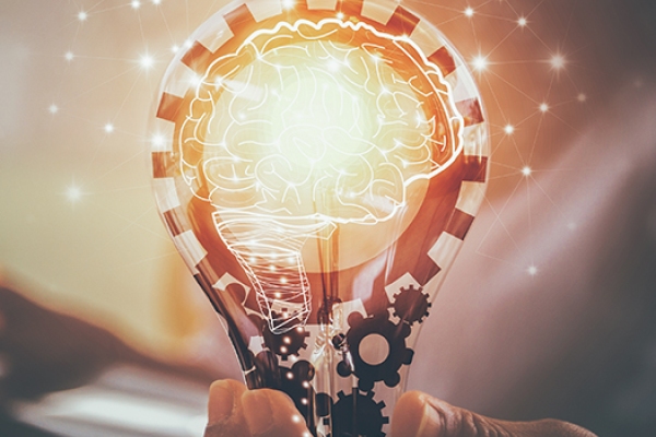 Hand holding lightbulb with innovative graphic overlays